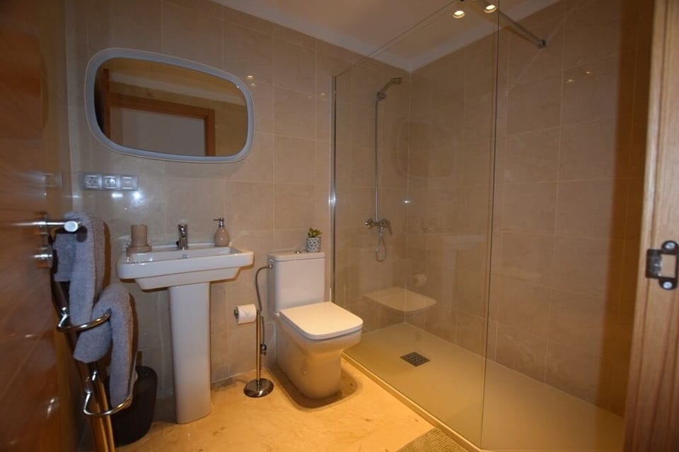 Marble tiled Second bathroom with Double walk-in shower and crystal glass