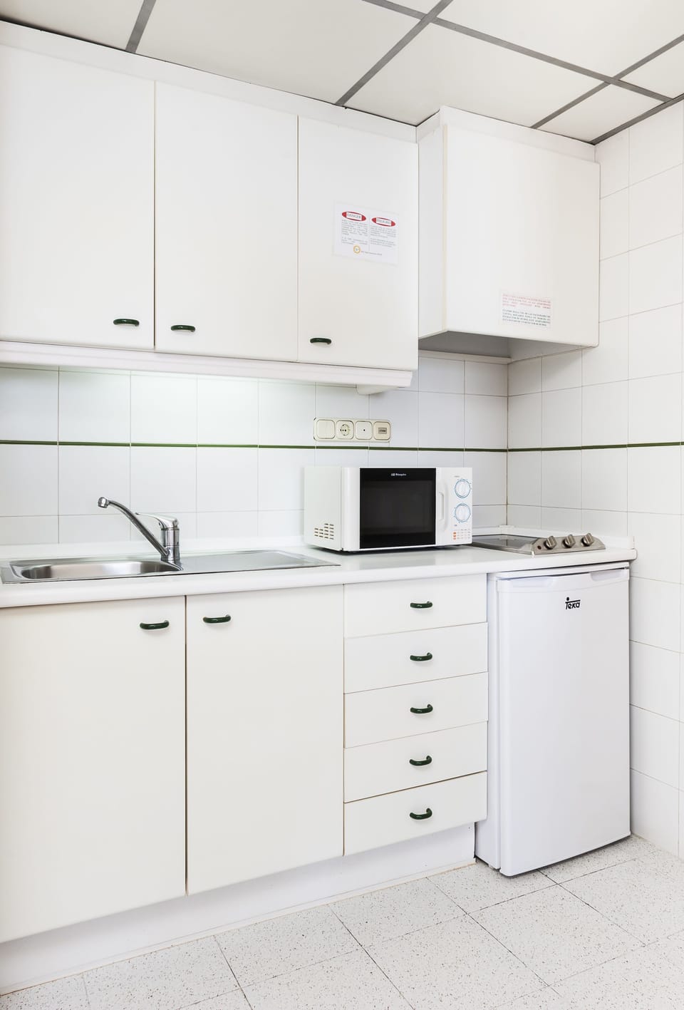 Fridge, microwave, coffee/tea maker, cookware/dishes/utensils