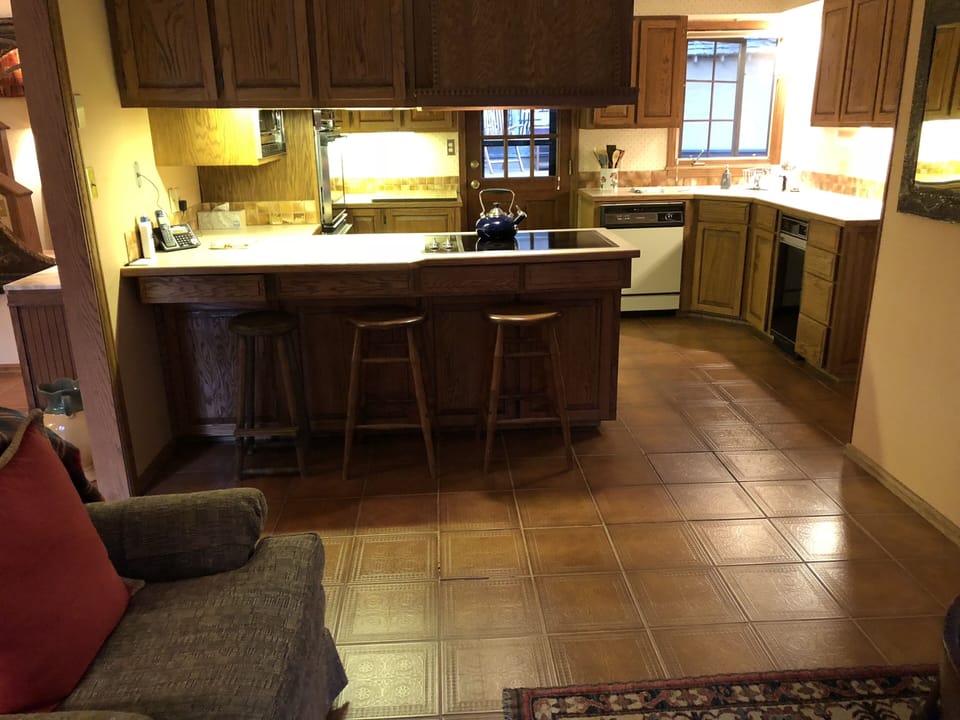 An overview of the kitchen. Fridge, pantry, and utility room around the corner.