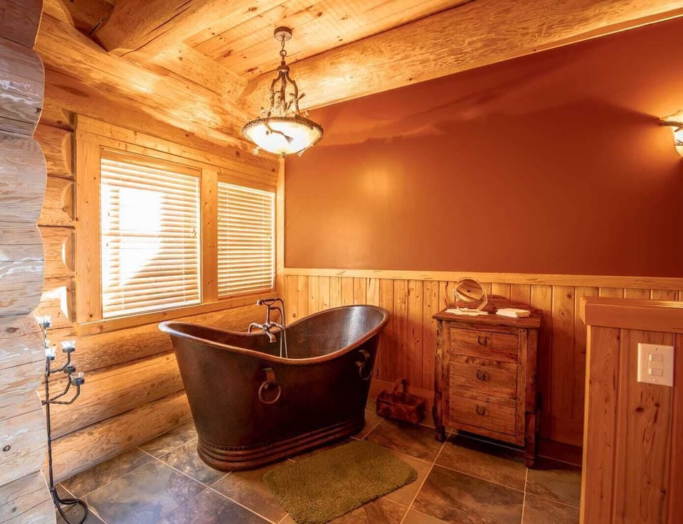 Unique copper bathtub in master bathroom