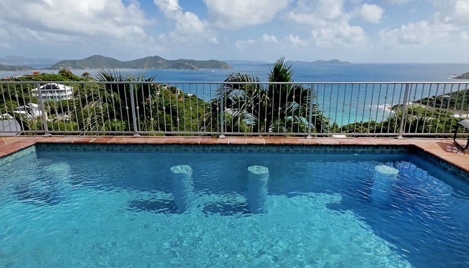 Heated pool features bar stools to hang out and relax