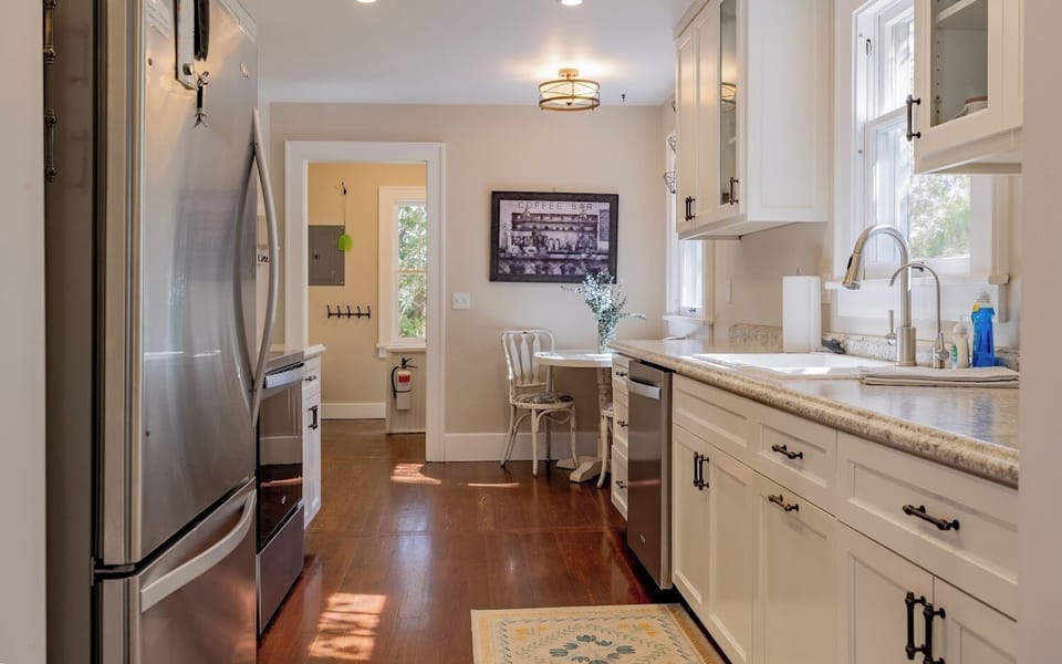 Galley style kitchen with modern appliances makes meal prep a pleasure and has a sunny breakfast nook