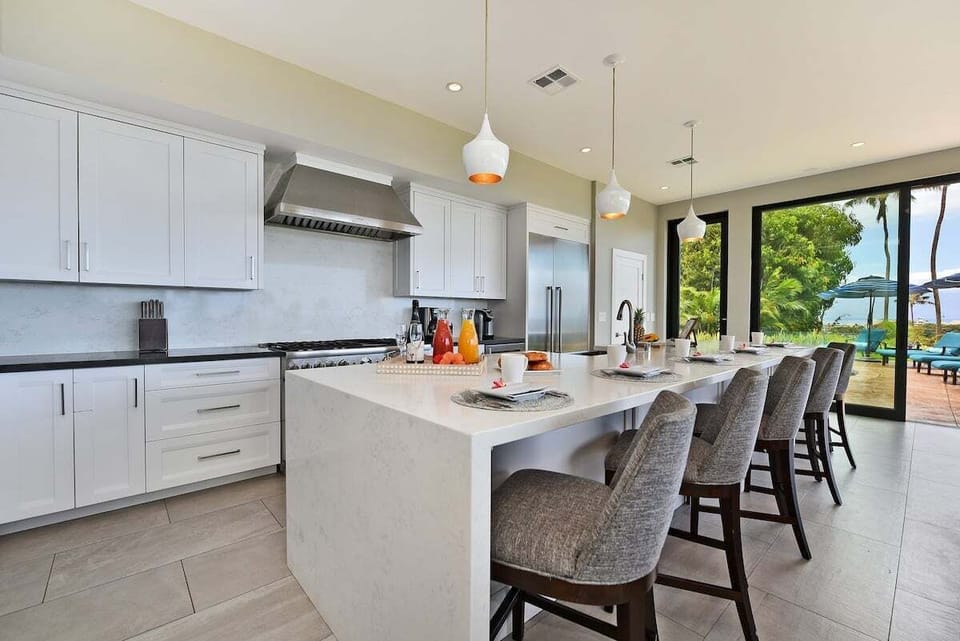 Prepare meals in this fully equipped kitchen featuring a large island and ocean views