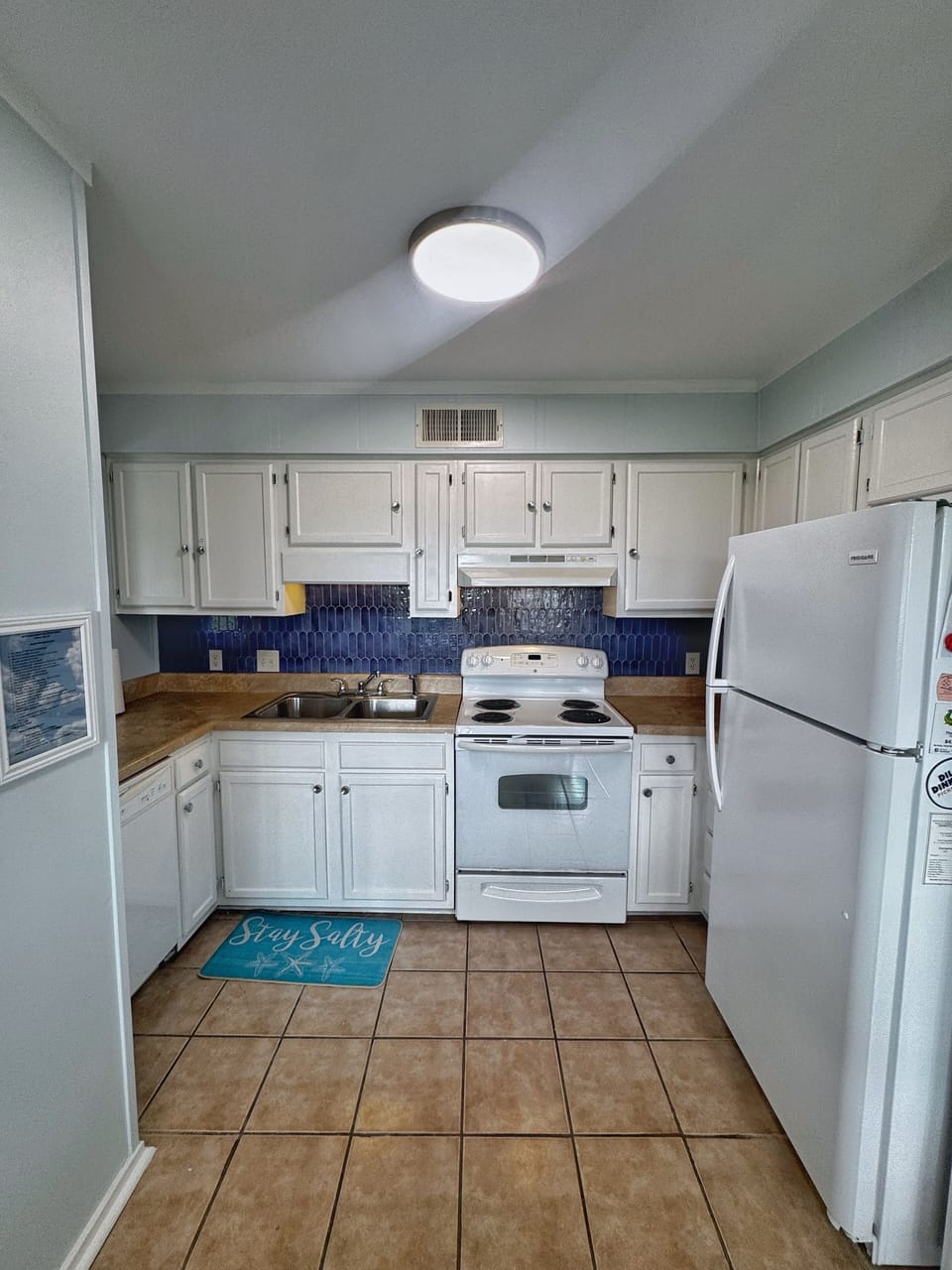 Freshly painted cabinets and new backsplash give the kitchen a modern feel.