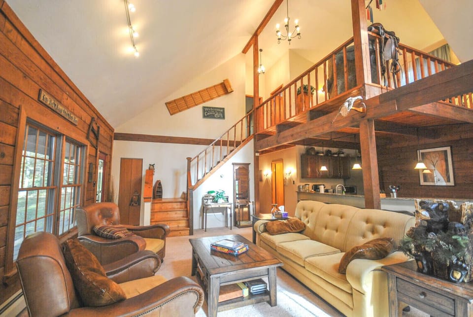 Living Room - Main Level. Spacious and high ceiling living area with comfy couches and chairs.