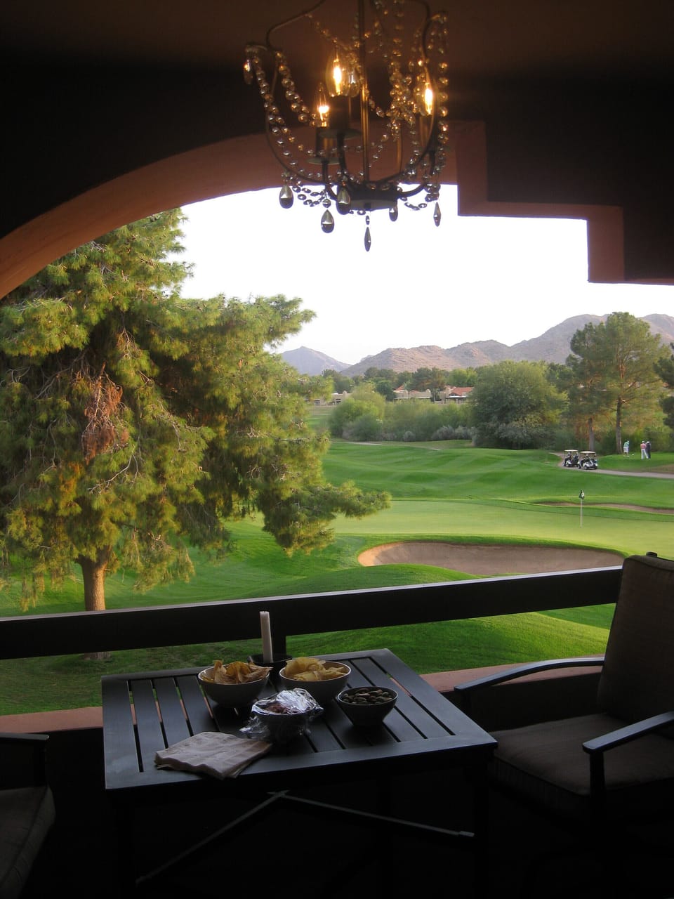 chandelier over balcony dining
