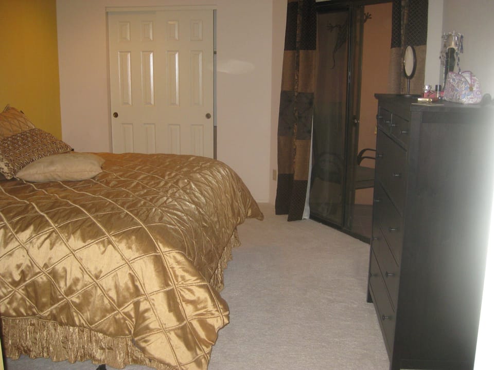 bedroom overlooks the balcony and the golf course (now has TV)