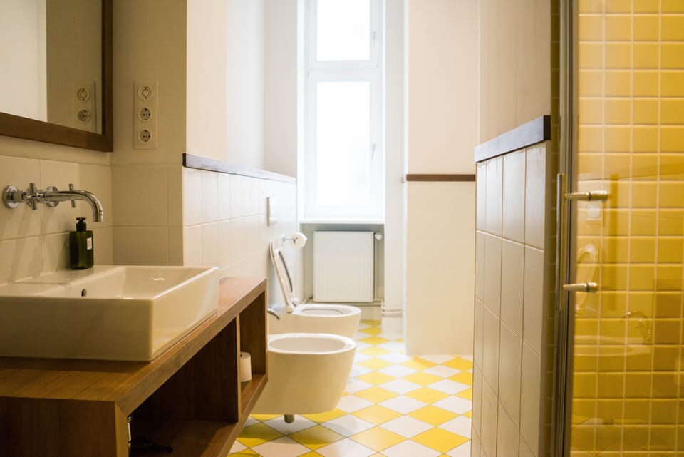 The yellow bathroom: italian tiles and walnut furniture and details