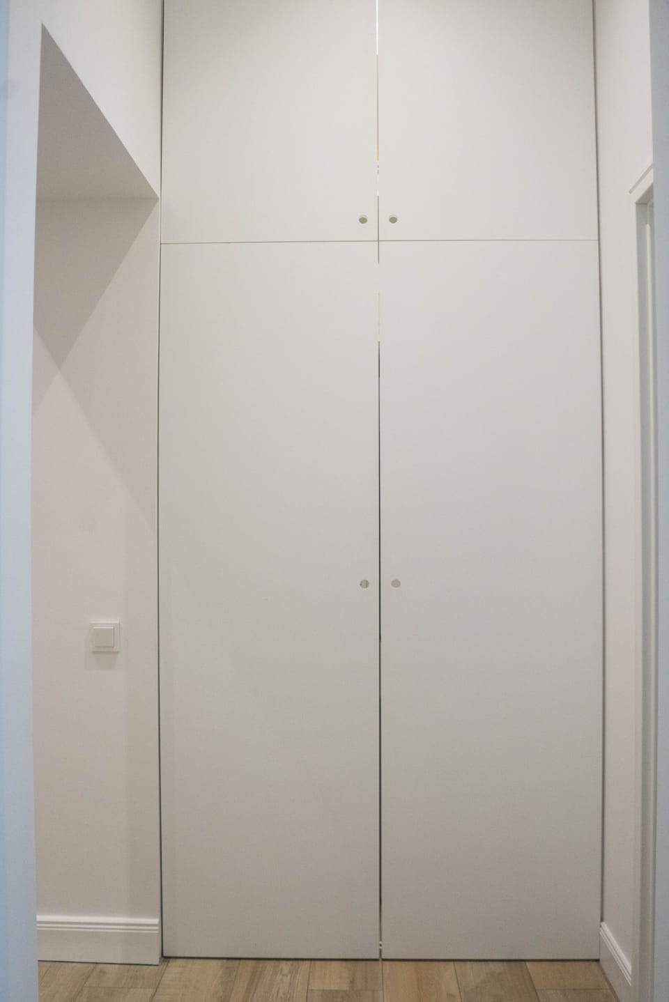 Two laundy machines and two driers well hidden in the corridor