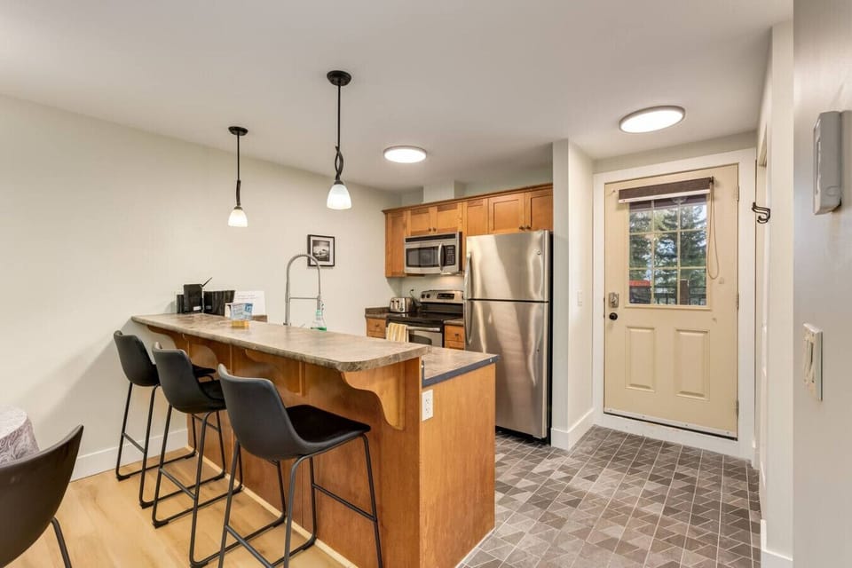 Well-stocked kitchen with stainless steel appliances.
