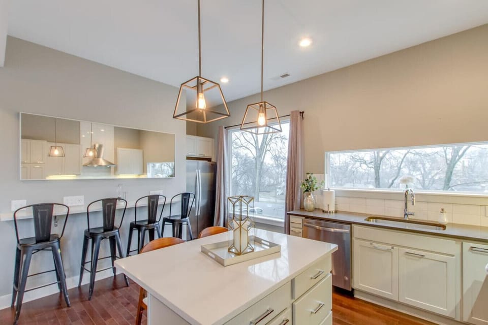 A warm dining area with pendant lighting and a long table is perfectly sized for group meals.