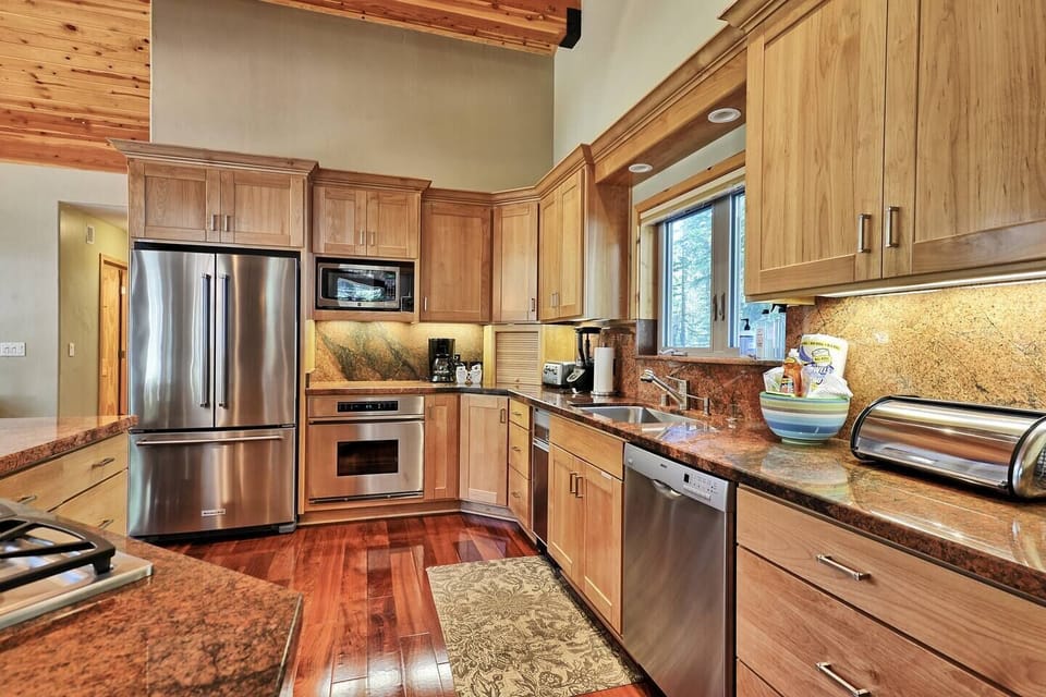The tasteful kitchen features stainless steel appliances, granite countertops, and everything you need for home-cooked meals
