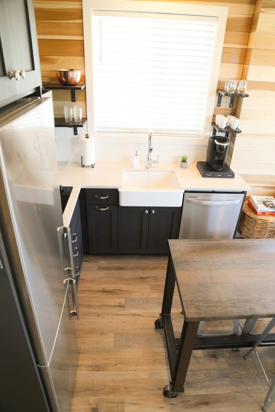 The well-appointed kitchen has what you need to cook delicious meals, including a convection microwave oven, stovetop, large fridge, coffee station, dishwasher, farmhouse sink and a table for 4.