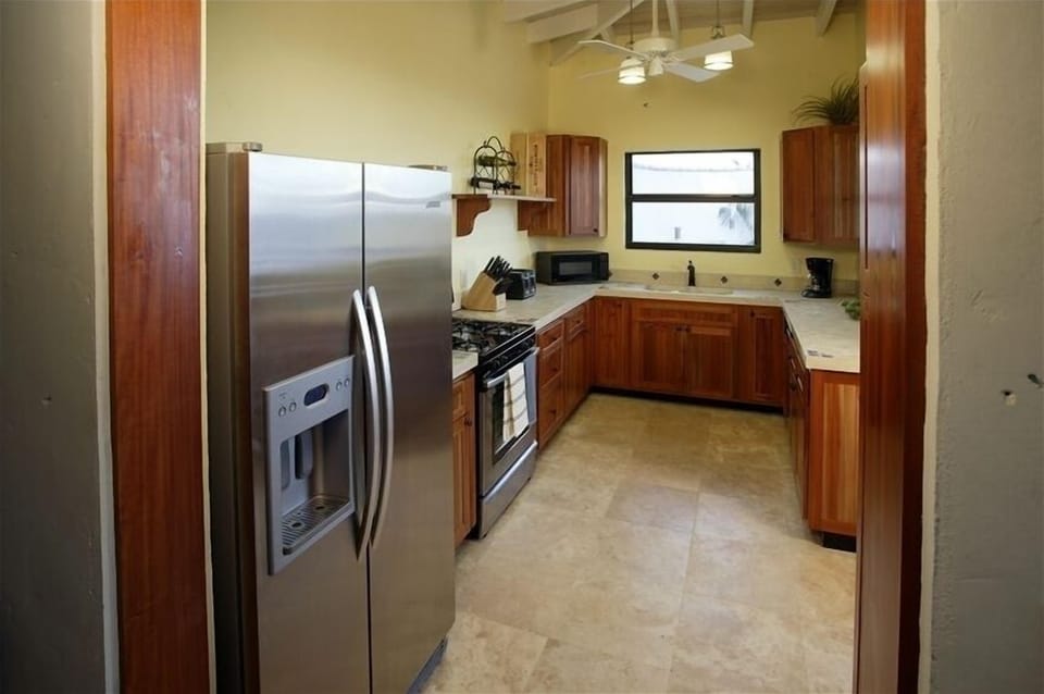 Fully equipped very large custom kitchen with pool and ocean views.