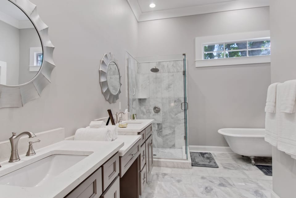 Master Bath with antique claw tub & glass stand-up shower. 
