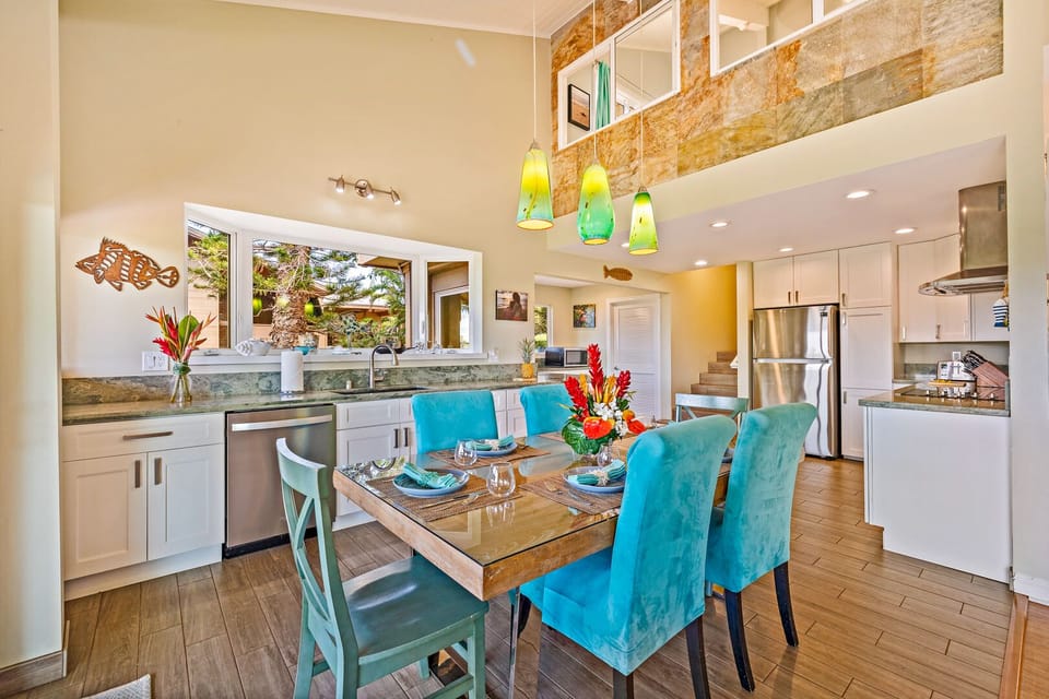 Elegant dining area with turquoise accents and a view of the lush surroundings, creating a relaxing and inviting atmosphere for meals.