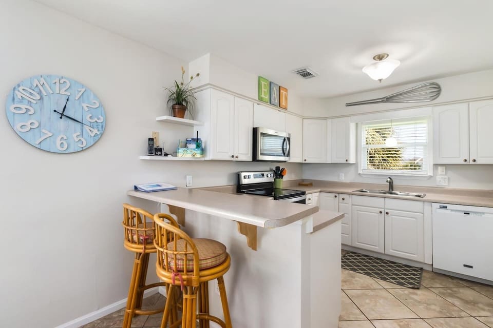 Cook breakfast while two guests perch at the kitchen bar — the morning routine runs better when everyone's in the same room.