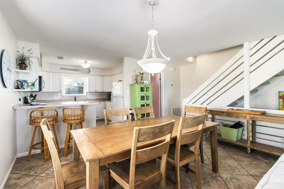 Seat the whole group around the wooden dining table and let the meal stretch as long as it wants — no rush here.