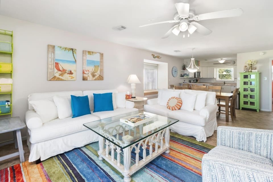 Find a second angle on the living room and the Gulf views keep showing up — there's no bad seat in this space.