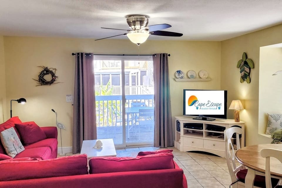 Your group lands here after the beach — sink into the sofa, flip on the Smart TV, and let the day slow down around you.