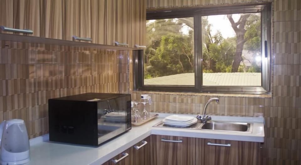 Executive Suite | Private kitchen | Fridge, electric kettle