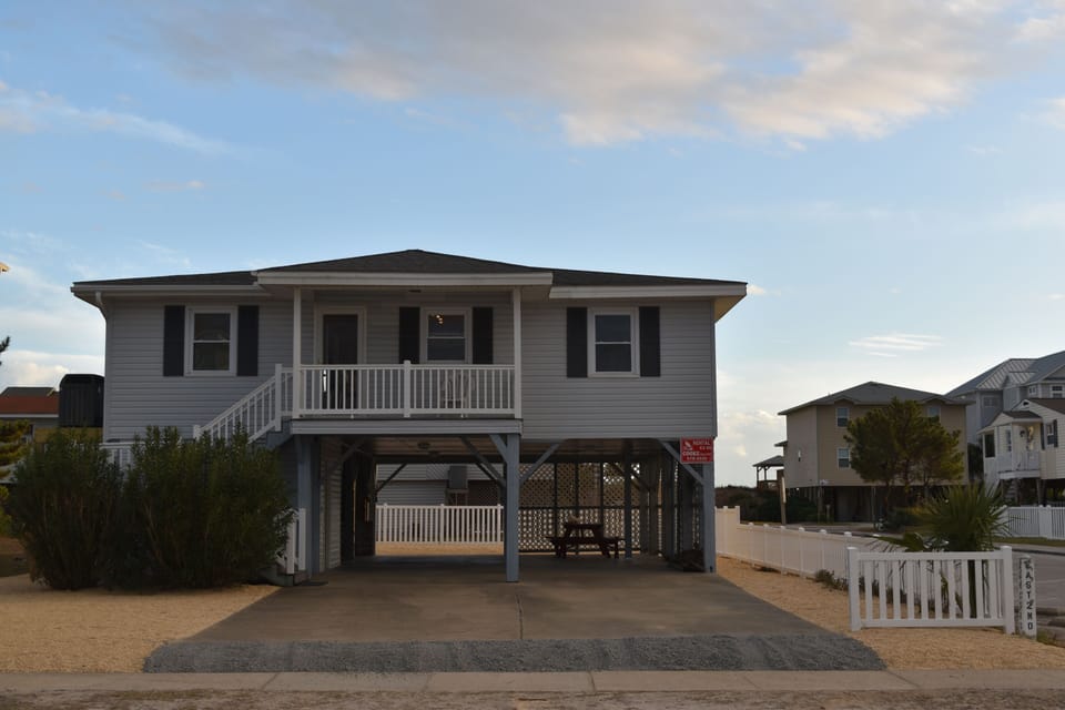 Front of the house with covered porch, plenty of parking space