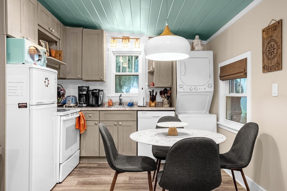 Dining table and kitchen with diswasher and garbage disposer.