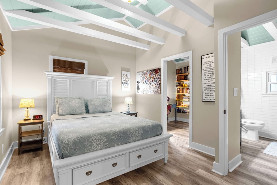 Bedroom with queen size bed with private office attached.