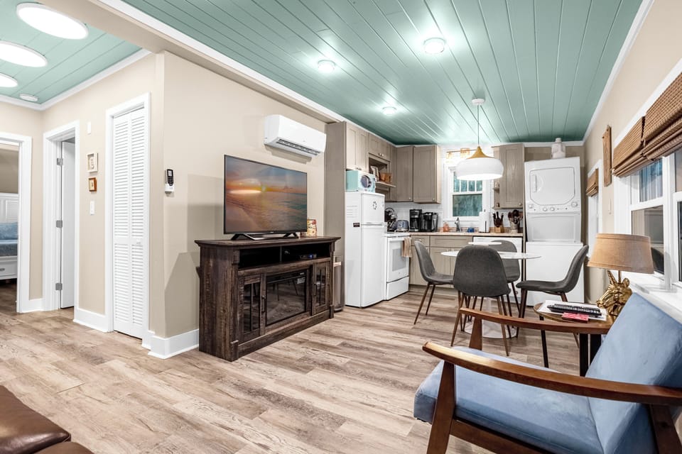 Family room with large flat screen TV. Electric fireplace underneath TV.