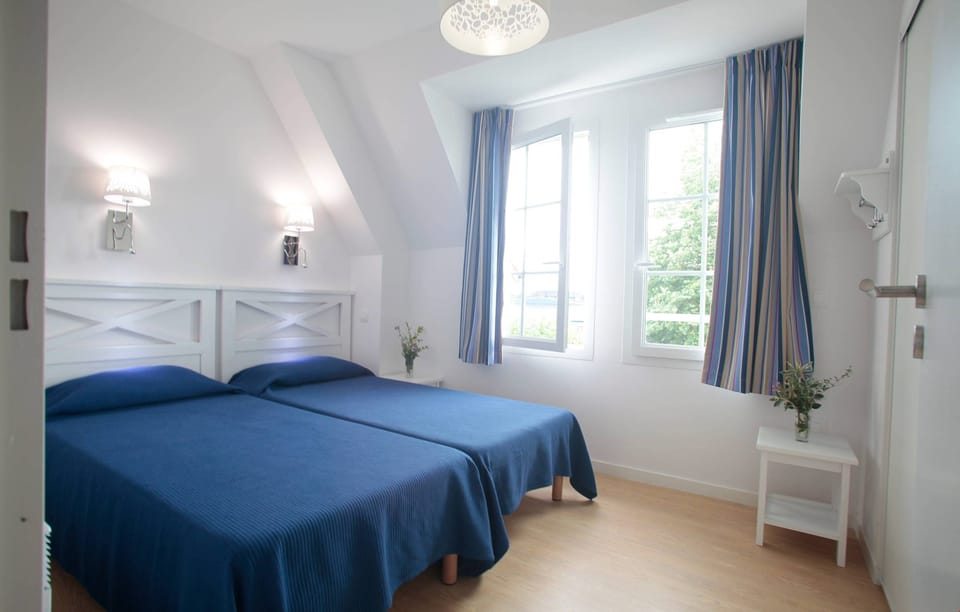 The second bedroom features 2 Single beds.