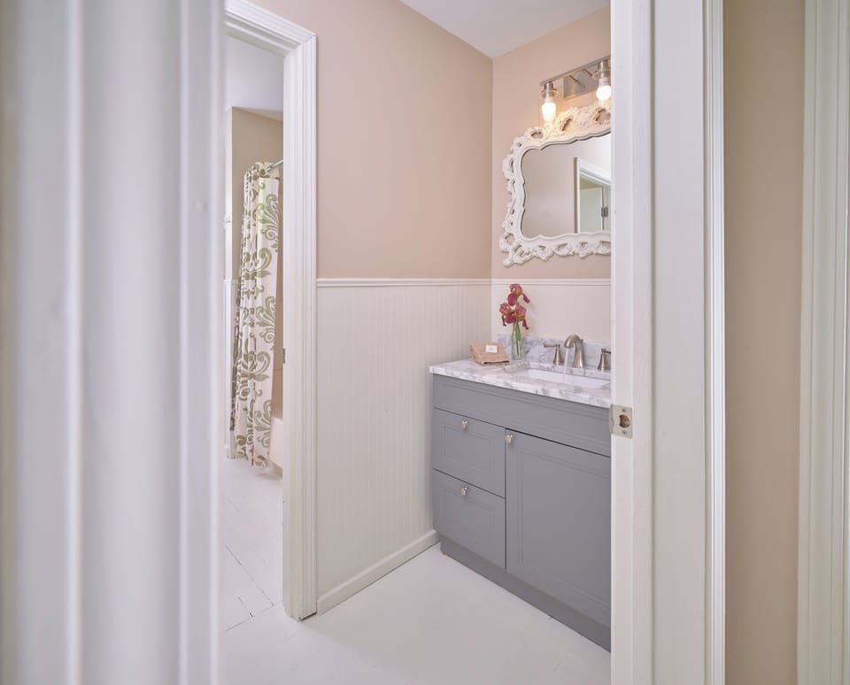 Hall bath with tub/shower in back.