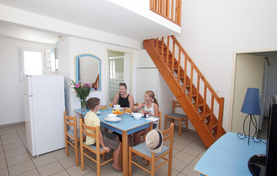 Prepare meals in the kitchenette and enjoy them at the dining table.
