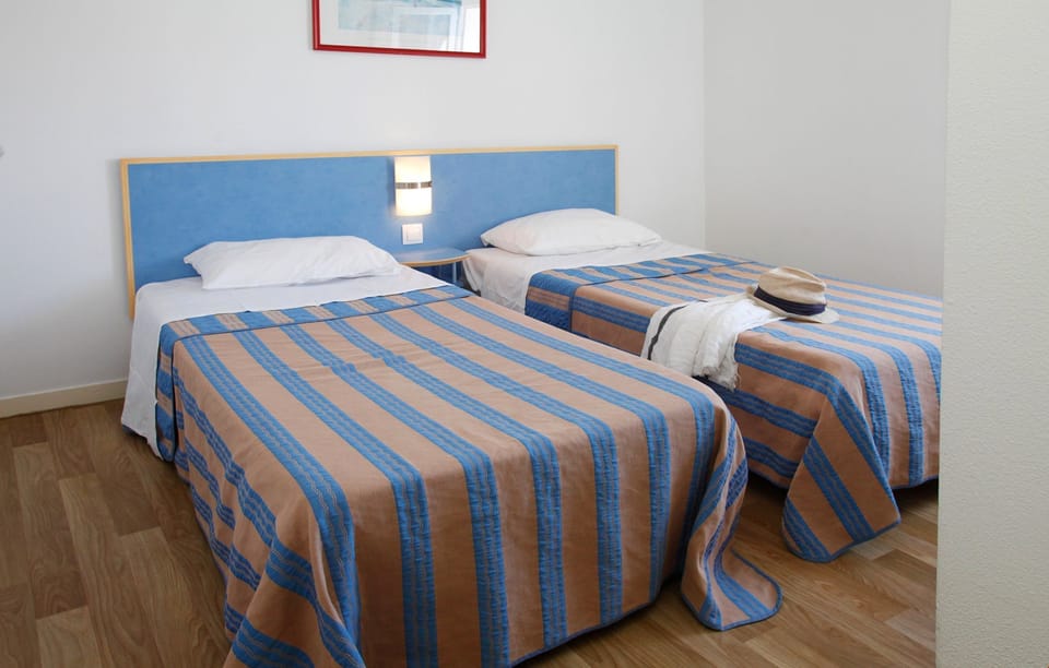 The second bedroom contains 2 Single beds.