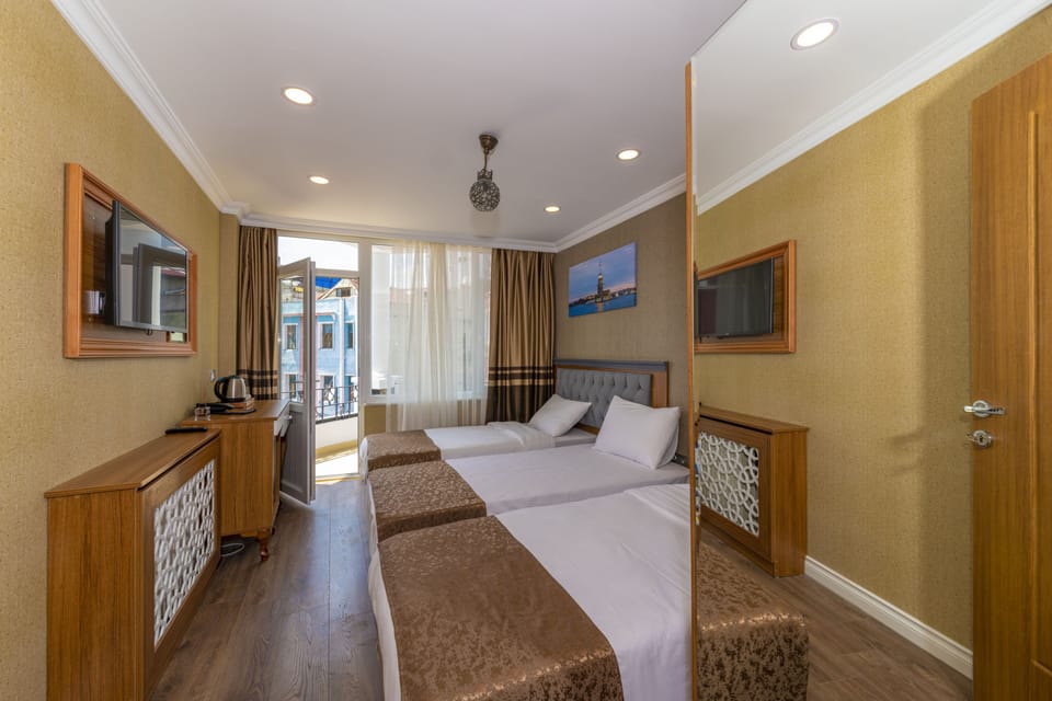 Standard Triple Room | Minibar, in-room safe, desk, blackout drapes