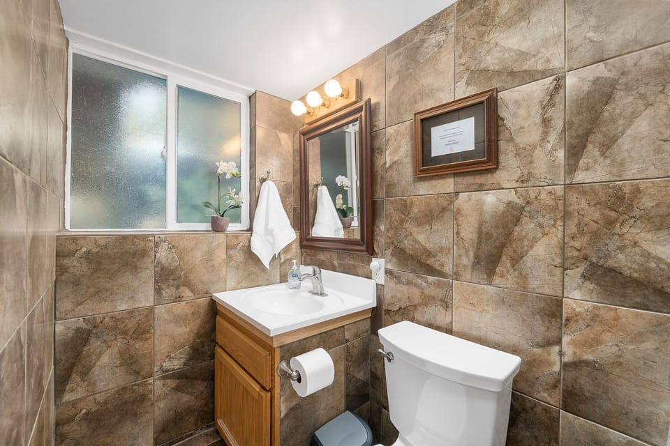 Newly remodeled glazed porcelain tile bathroom and shower.