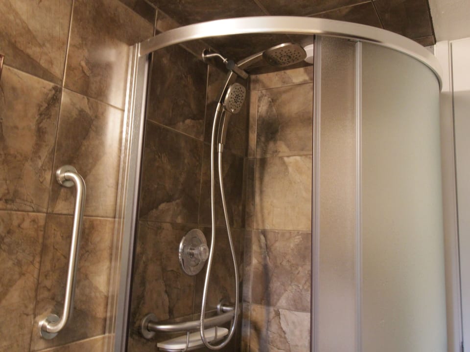 Newly remodeled glazed porcelain tile bathroom and shower.