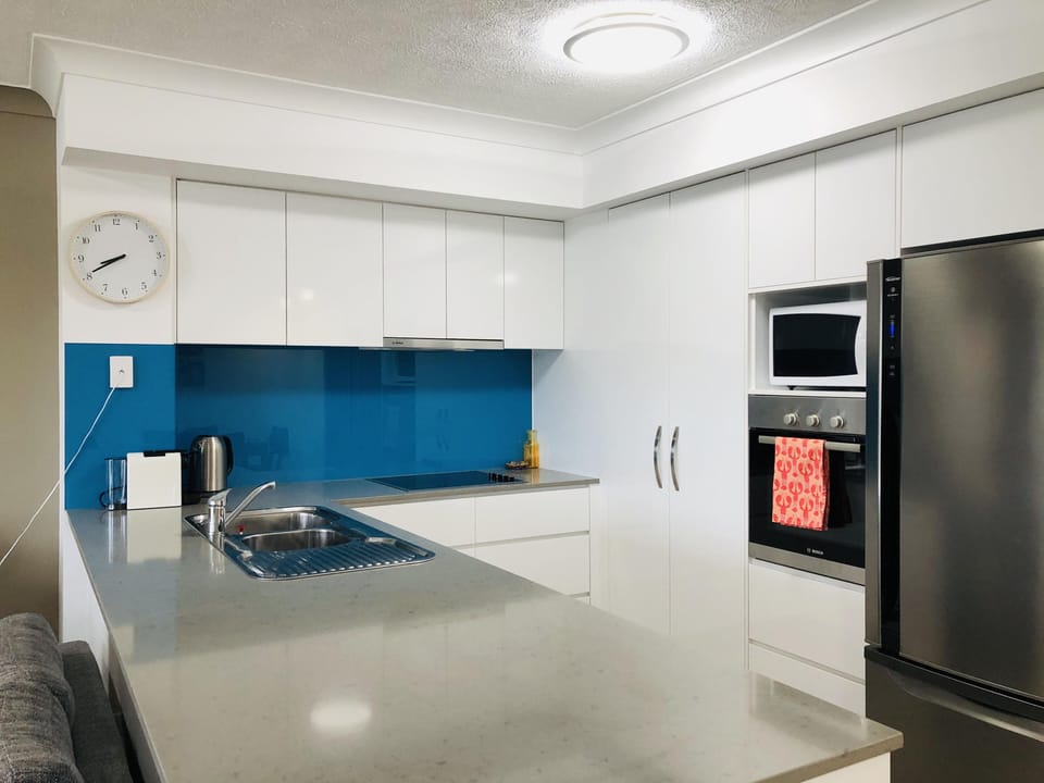 Modern kitchen complete with coffee machine, kettle, toaster & cooking utensils