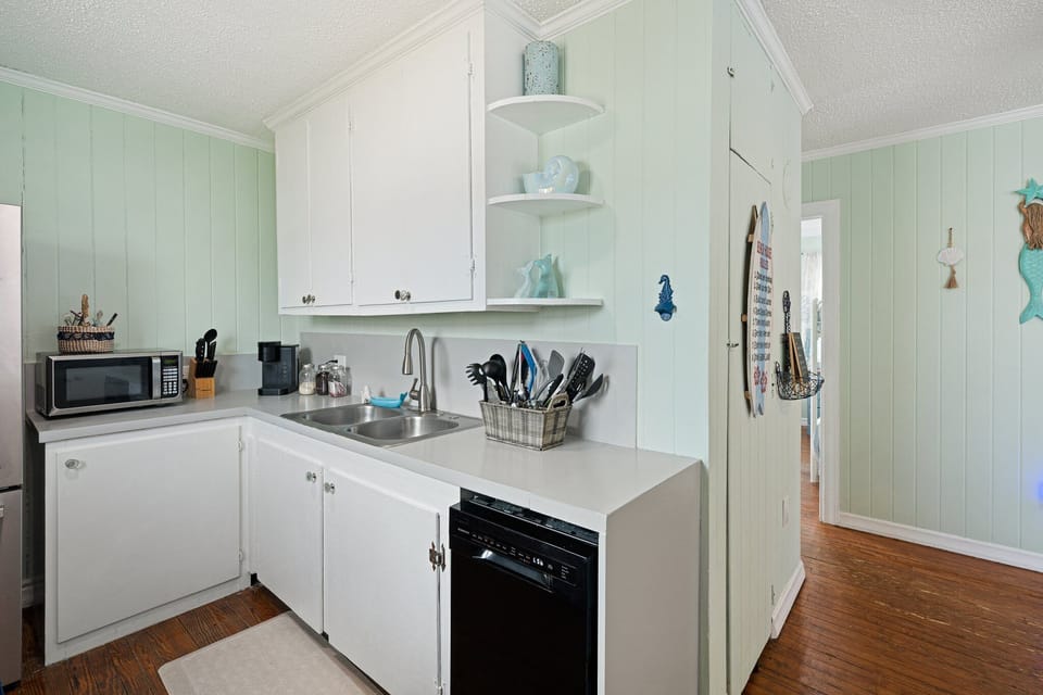 Your bright coastal kitchen awaits with everything you need - full appliances, plenty of counter space, and charming seaside touches.