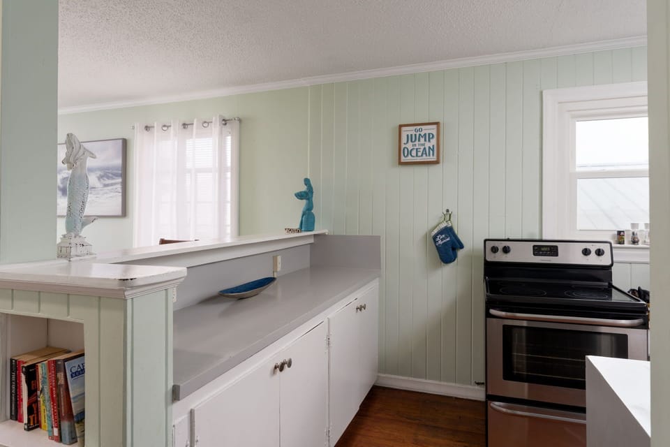Your coastal-themed kitchen awaits with charming nautical touches and modern appliances for effortless meal prep during your beach getaway.