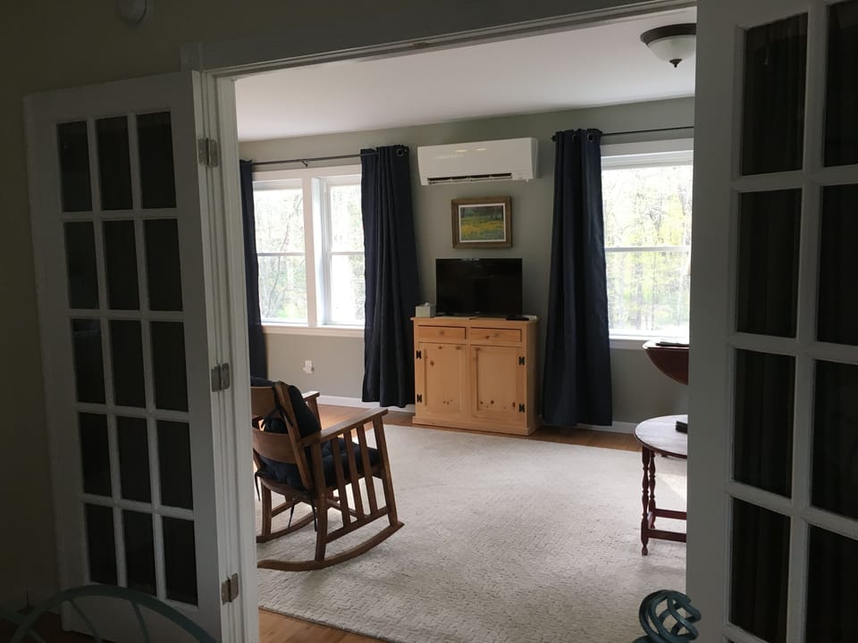 view from the bedroom into the living room and west facing windows