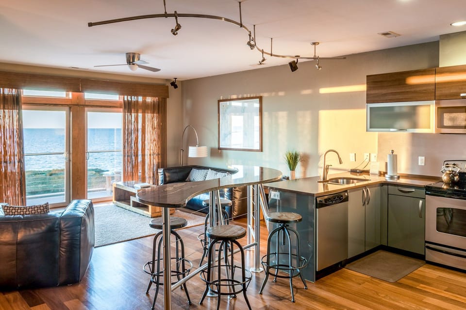 Living Area & Full Kitchen with Water Front Balcony Access