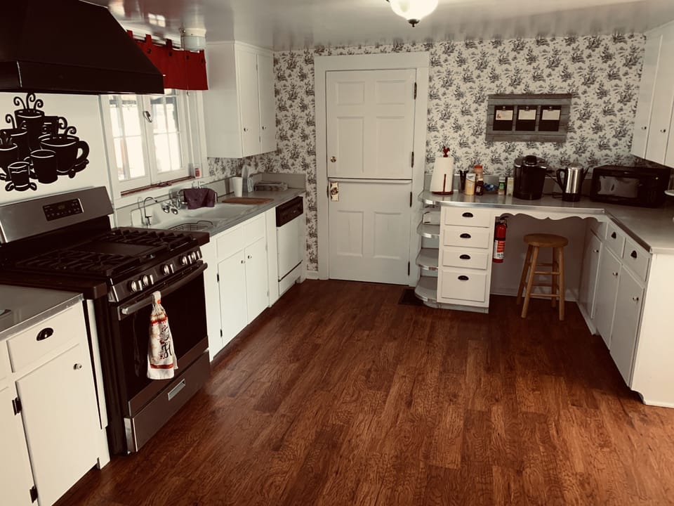 Full-size fridge, microwave, cookware/dishes/utensils