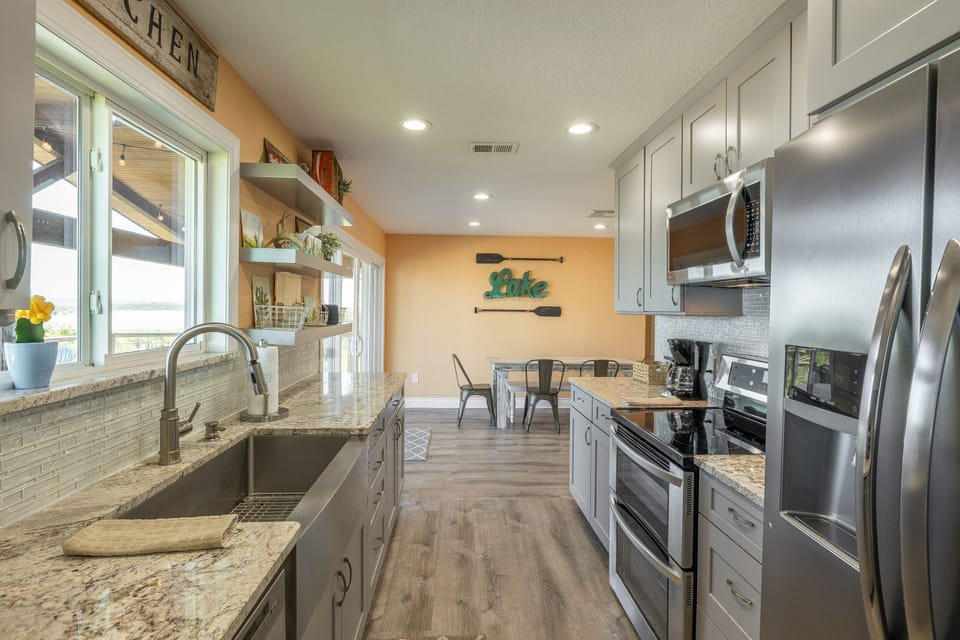 Kitchen opens to dining area + lake view
