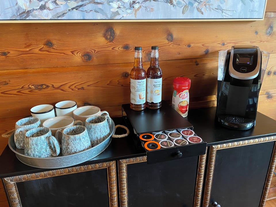 Complimentary coffee bar stocked with initial supply of K-pods, sugar packets.