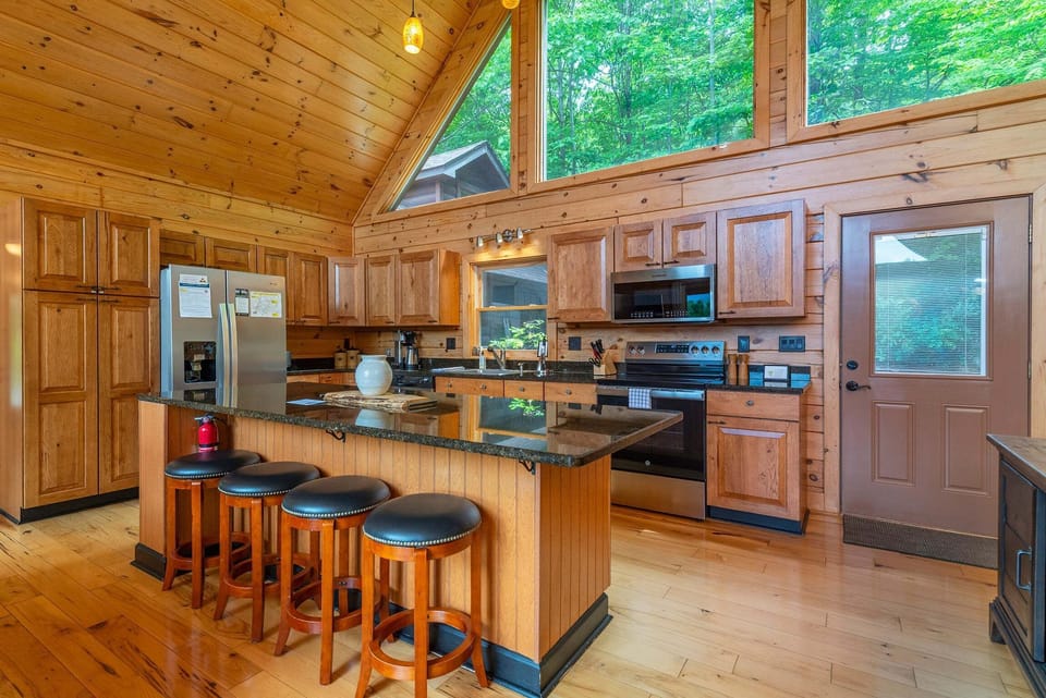 Kitchen with bar seating for 4, a dishwasher, and a standard Drip-style coffeemaker.