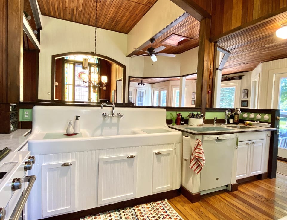Open kitchen. View of 20’s farm sink and dishwasher. View facing dining room