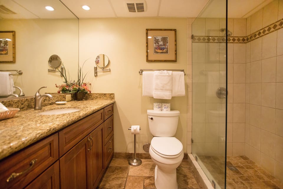 Step into your private bathroom featuring warm granite countertops, plush towels, and a spacious walk-in shower—your personal retreat after a day of adventure.