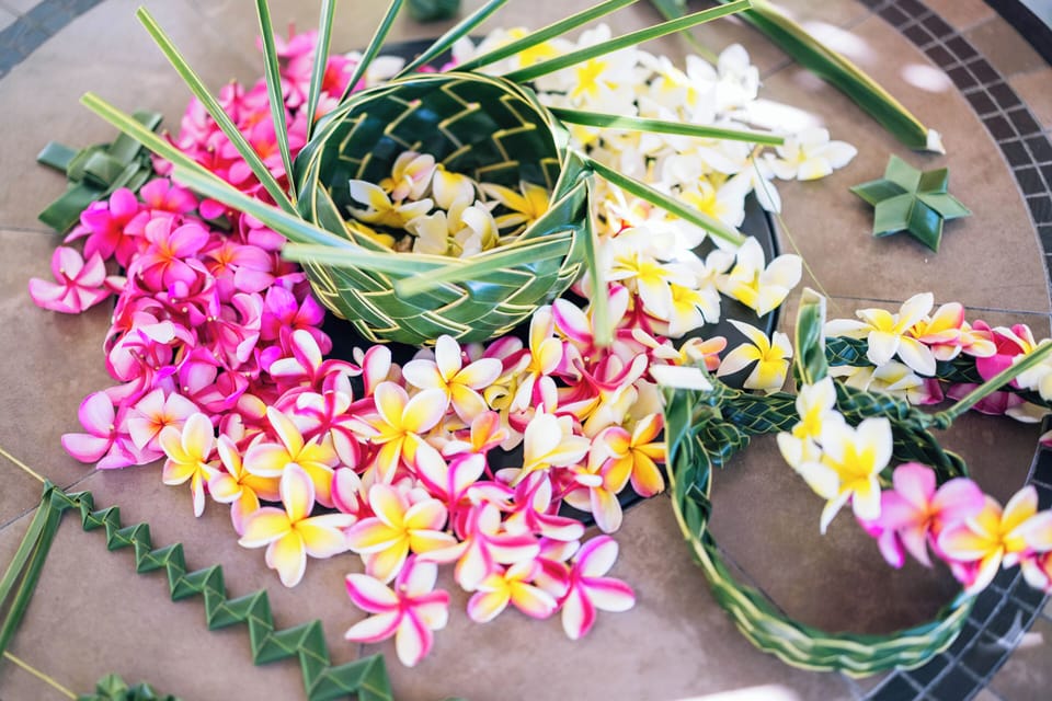 Handcrafted tropical flower arrangements featuring plumeria blooms in pink, yellow, and white welcome you to this island-inspired retreat.