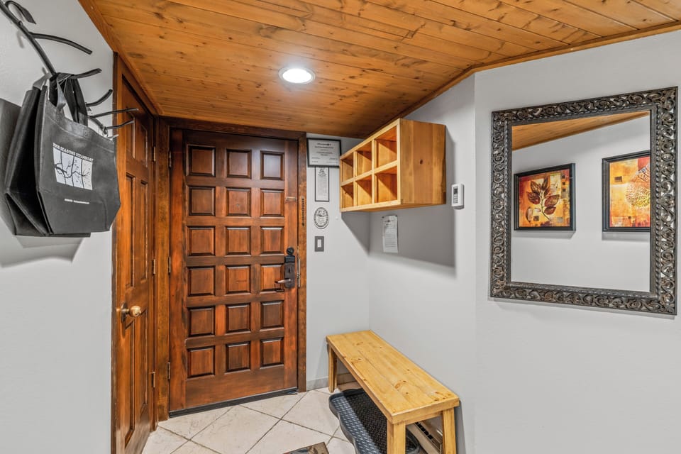 Entry with storage cubbies, bench and a hidden laundry closet..