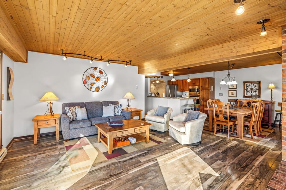 Living room with a view into the dining room and kitchen,